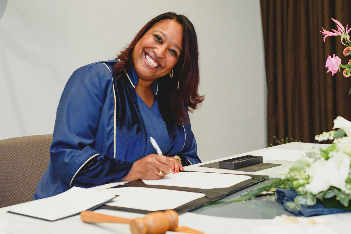 Registrar signing documents during civil wedding in Amsterdam