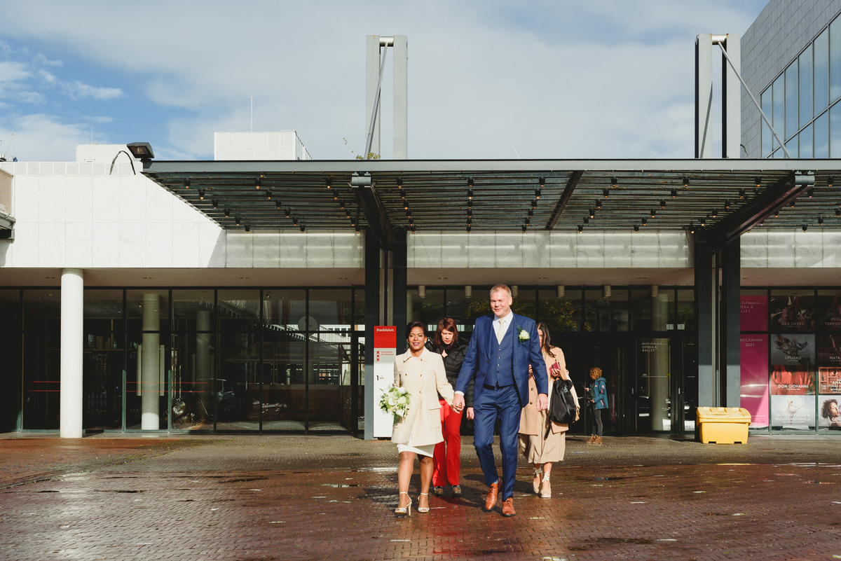 Couple walking towards canal boat wedding in Amsterdam