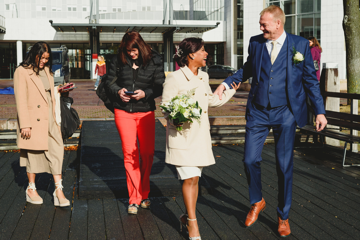 Family walking towards canal boat wedding in Amsterdam