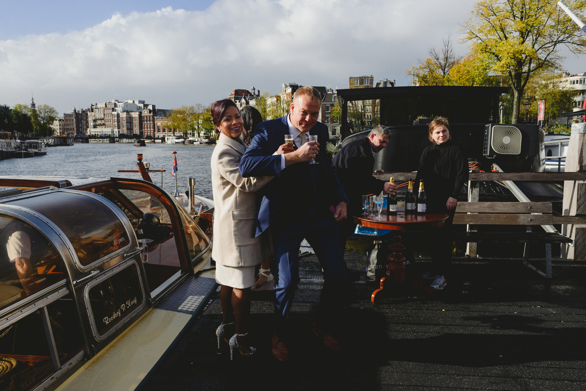 Wedding toast on canal boat after Gemeente Amsterdam ceremony