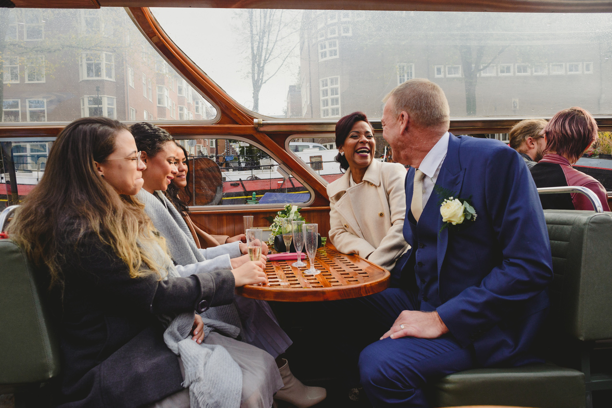 Family celebrating on canal boat wedding in Amsterdam