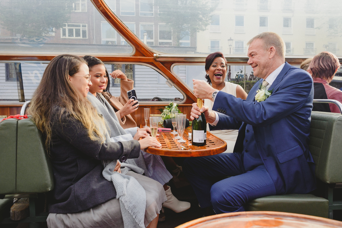 Wedding toast on canal boat after Gemeente Amsterdam ceremony