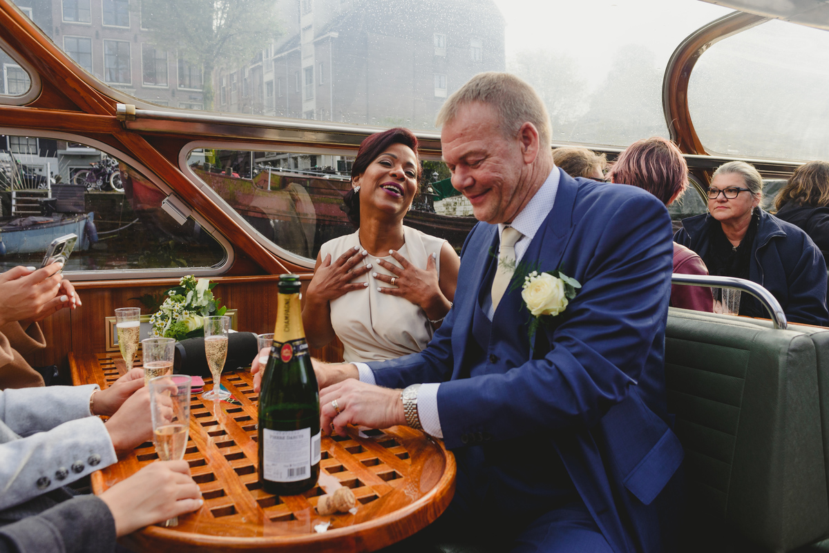 Wedding toast on canal boat after Gemeente Amsterdam ceremony