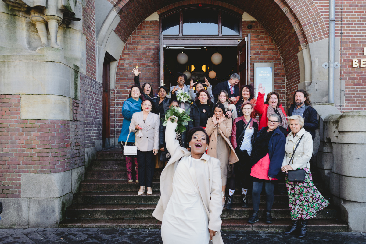 Bouquet toss on the steps of Beurs van Berlage during intimate Amsterdam wedding