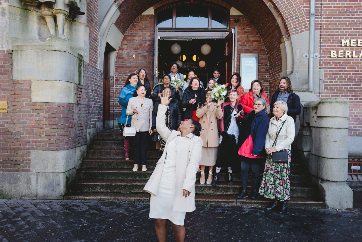 Wedding bouquet toss outside Beurs van Berlage in Amsterdam city center