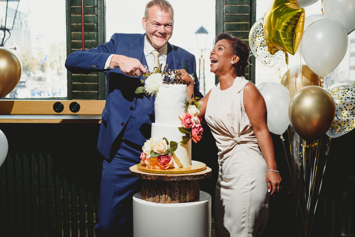 Wedding cake cutting at intimate Amsterdam reception venue