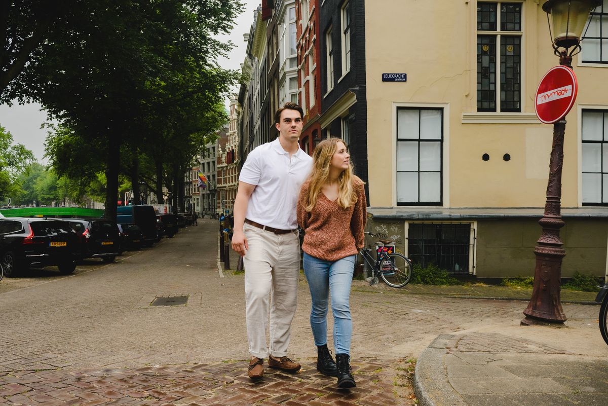 Couple walking together along a quiet Amsterdam street near the canals.