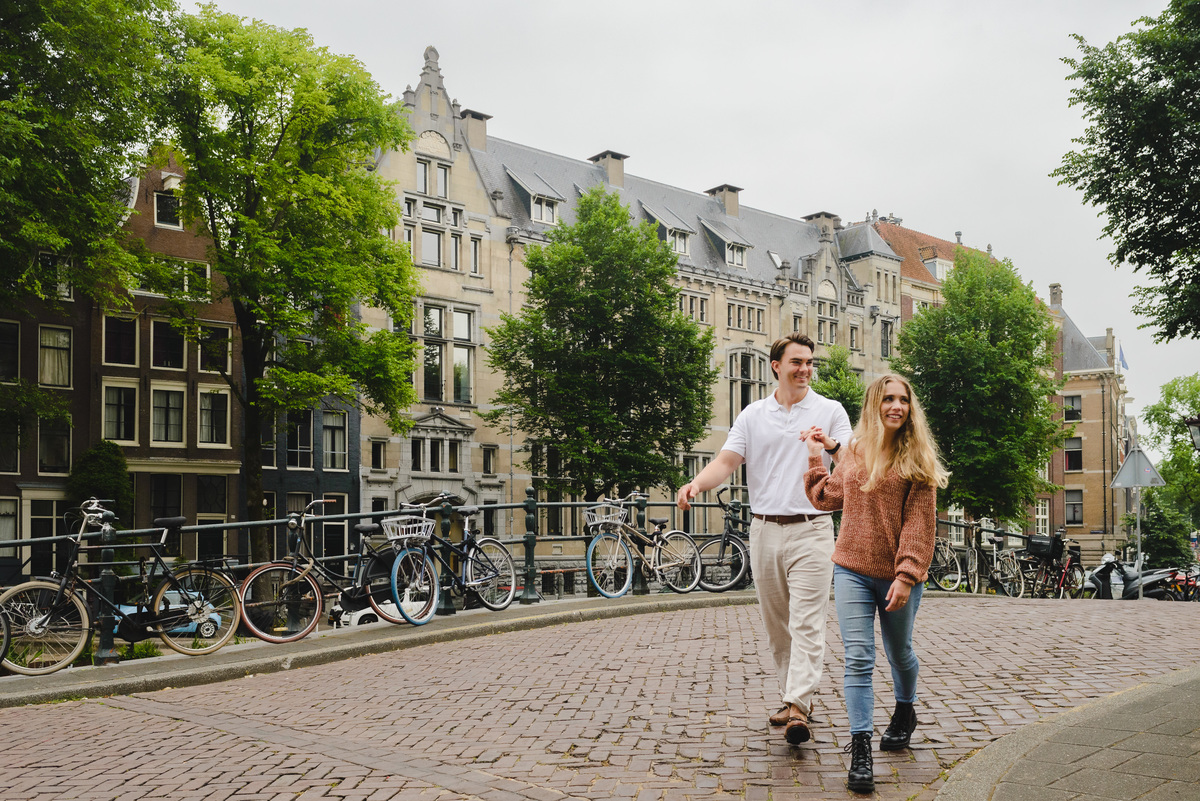 Couple walking together along a quiet Amsterdam street near the canals.