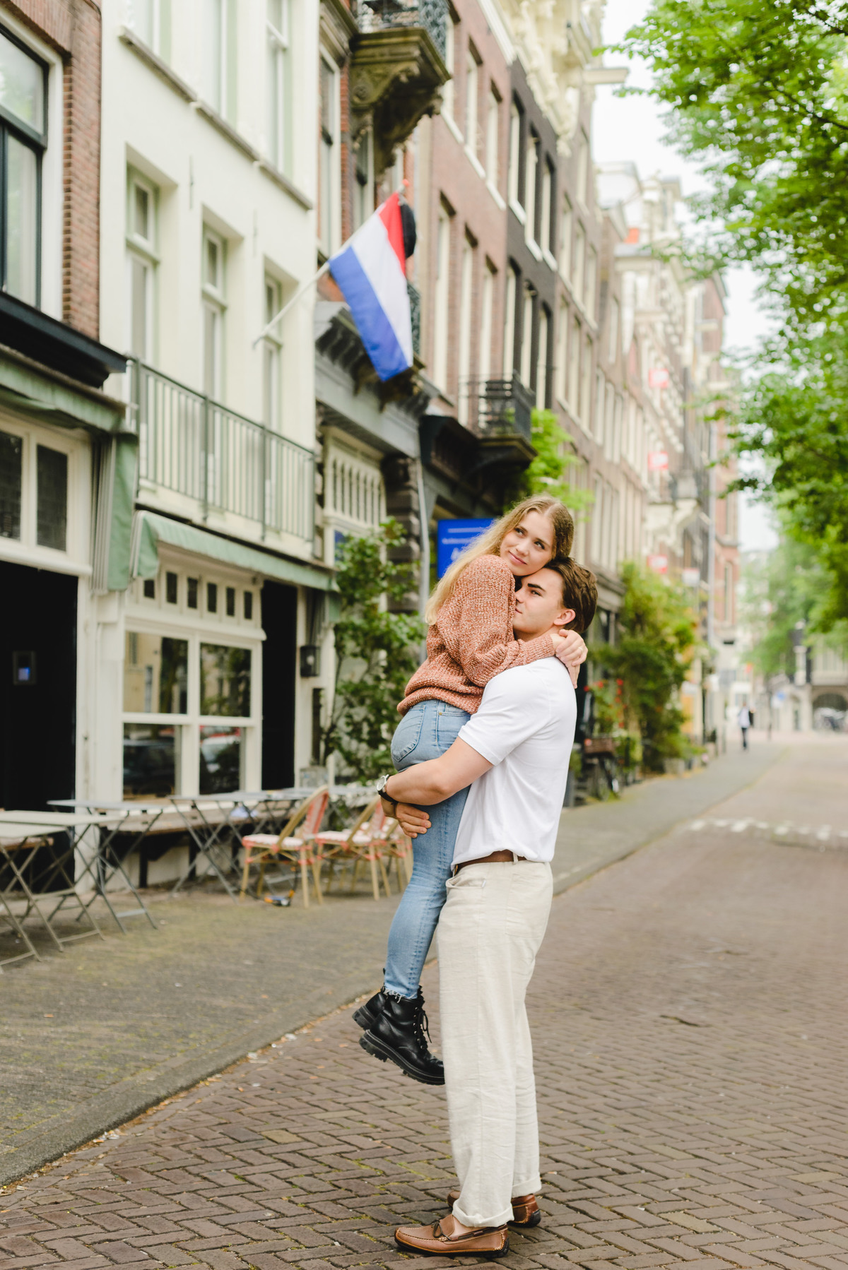 Documentary style couple photo capturing a relaxed walk near Amsterdam canals.