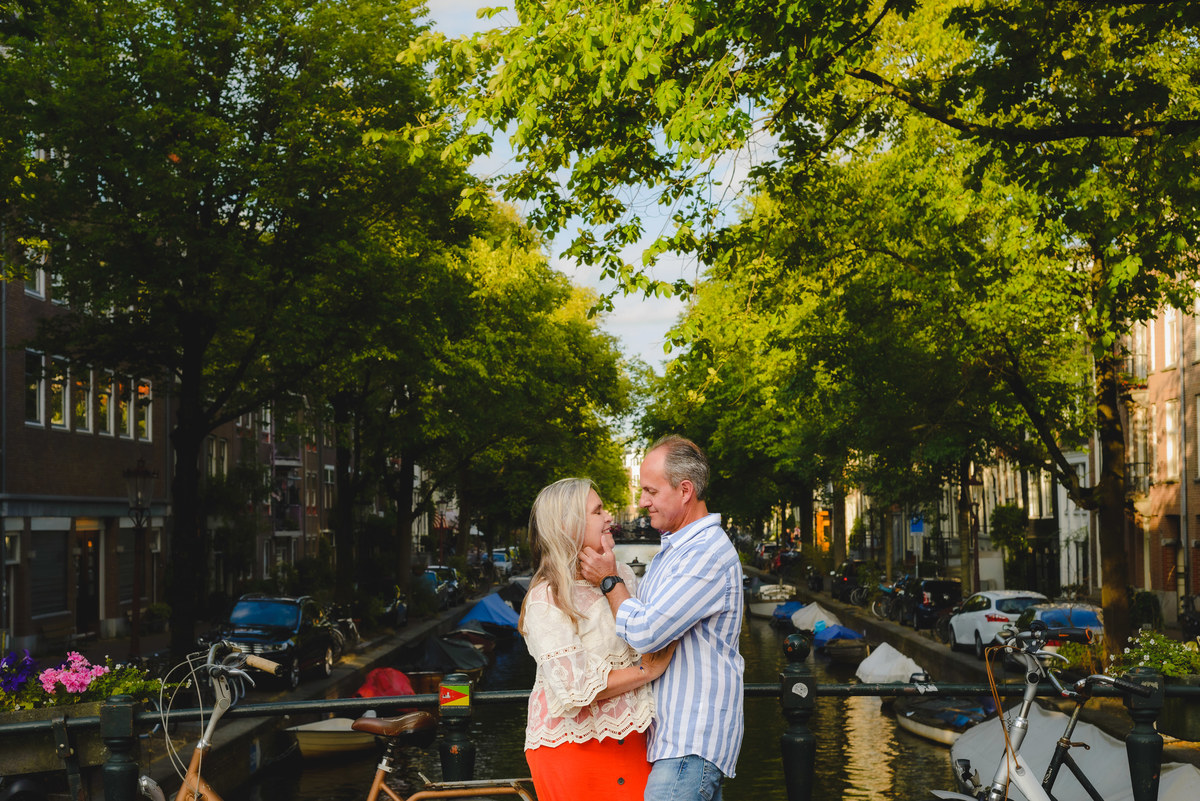 Couple standing by canal near Anne Frank House