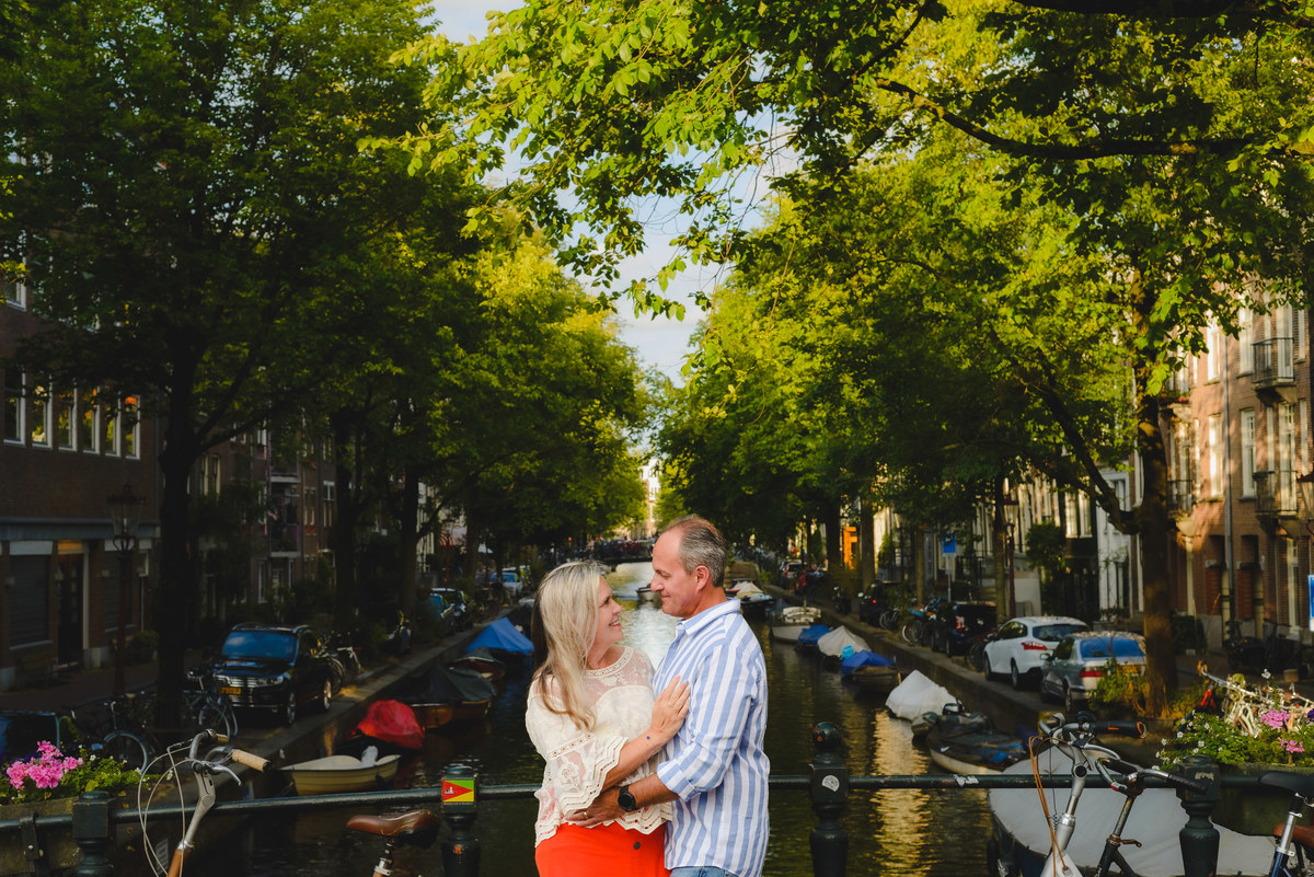 Couple standing by canal near Anne Frank House