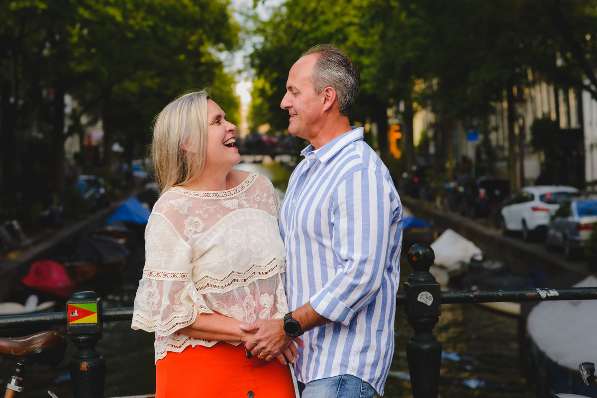 Couple standing by canal near Anne Frank House