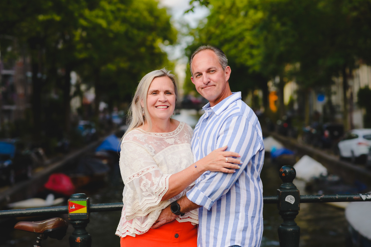 Couple standing by canal near Anne Frank House