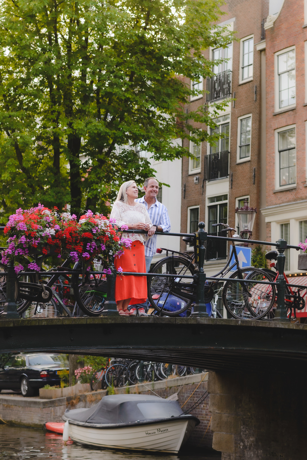 Couple standing by canal near Anne Frank House