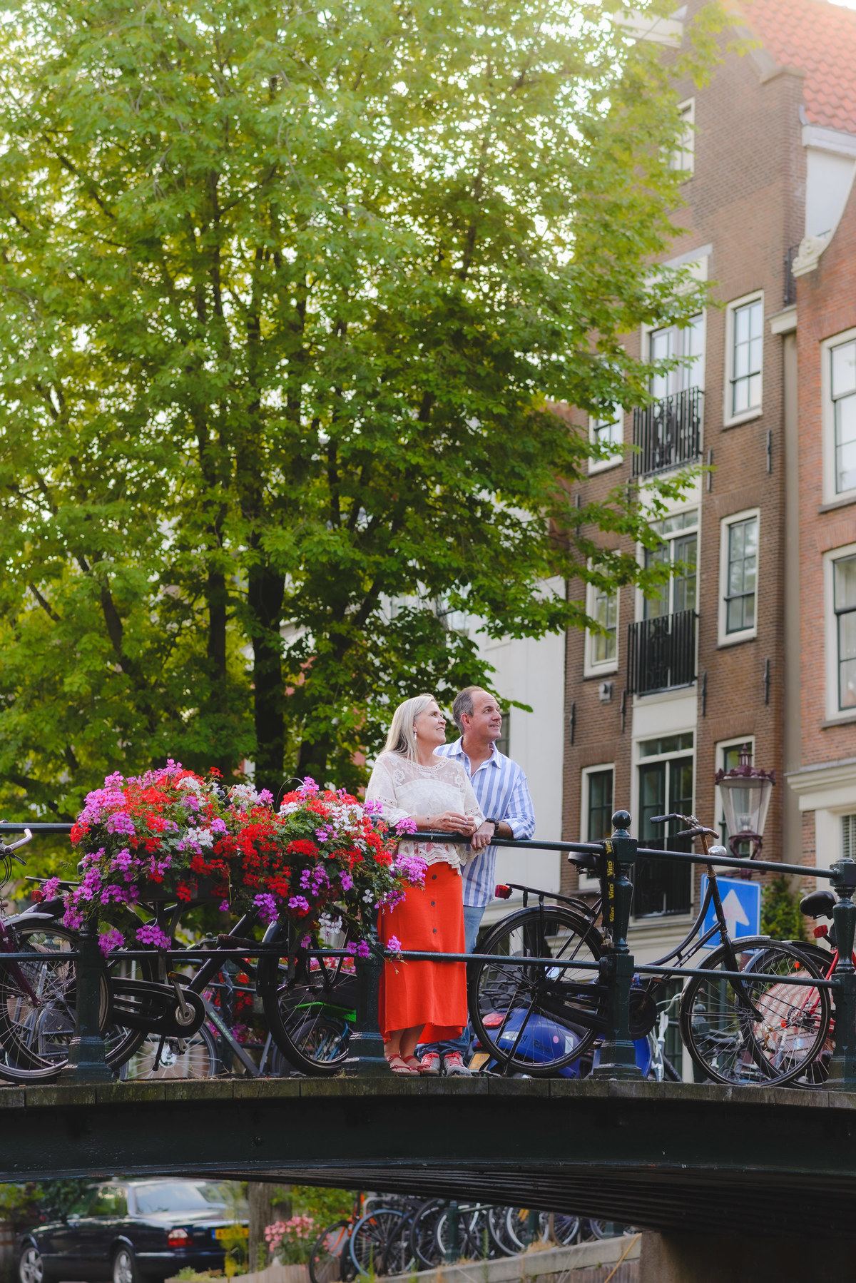 Couple standing by canal near Anne Frank House