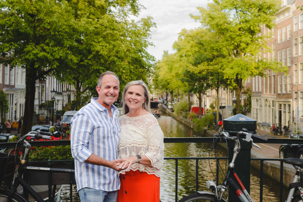 Couple standing by canal near Anne Frank House