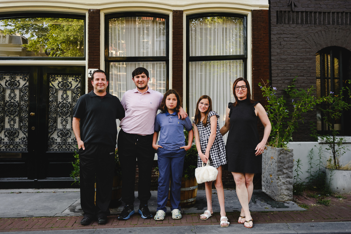 Family portrait in Amsterdam with historic canal houses in the background