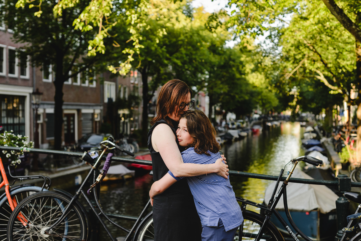 Parent and child moment captured naturally in Amsterdam streets