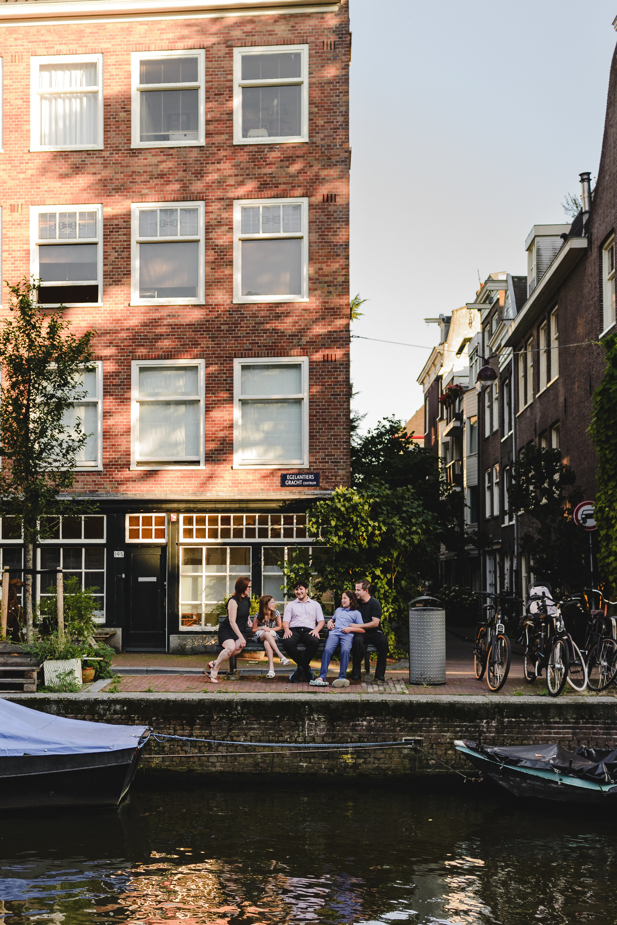 Family portrait in Amsterdam with historic canal houses in the background