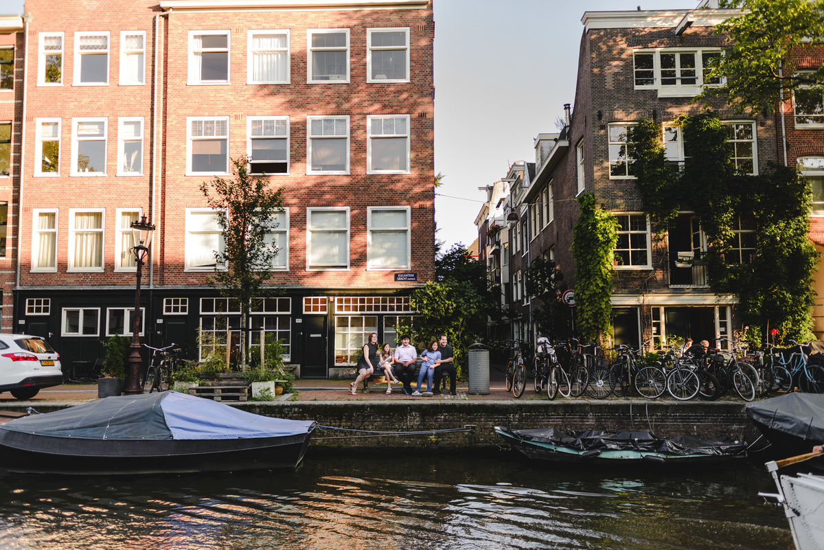 Family portrait in Amsterdam with historic canal houses in the background