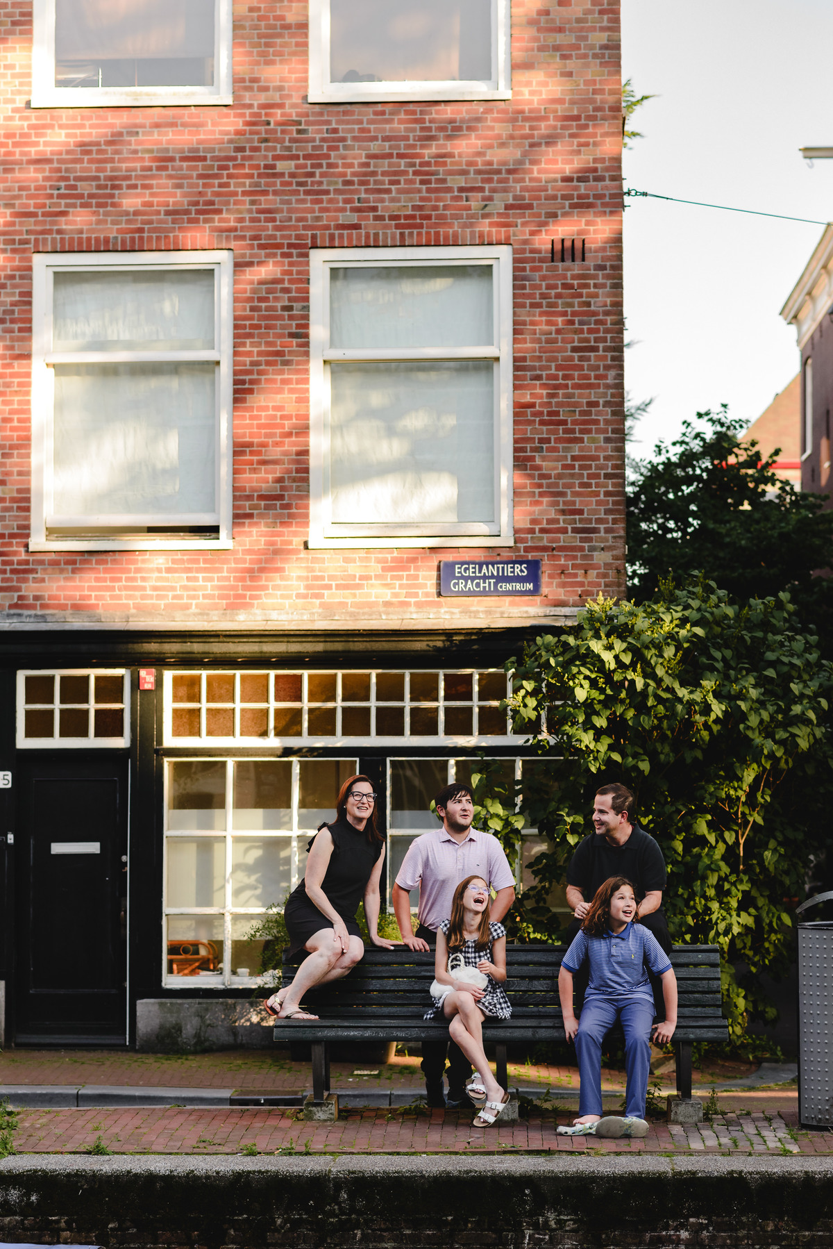 Family portrait in Amsterdam with historic canal houses in the background