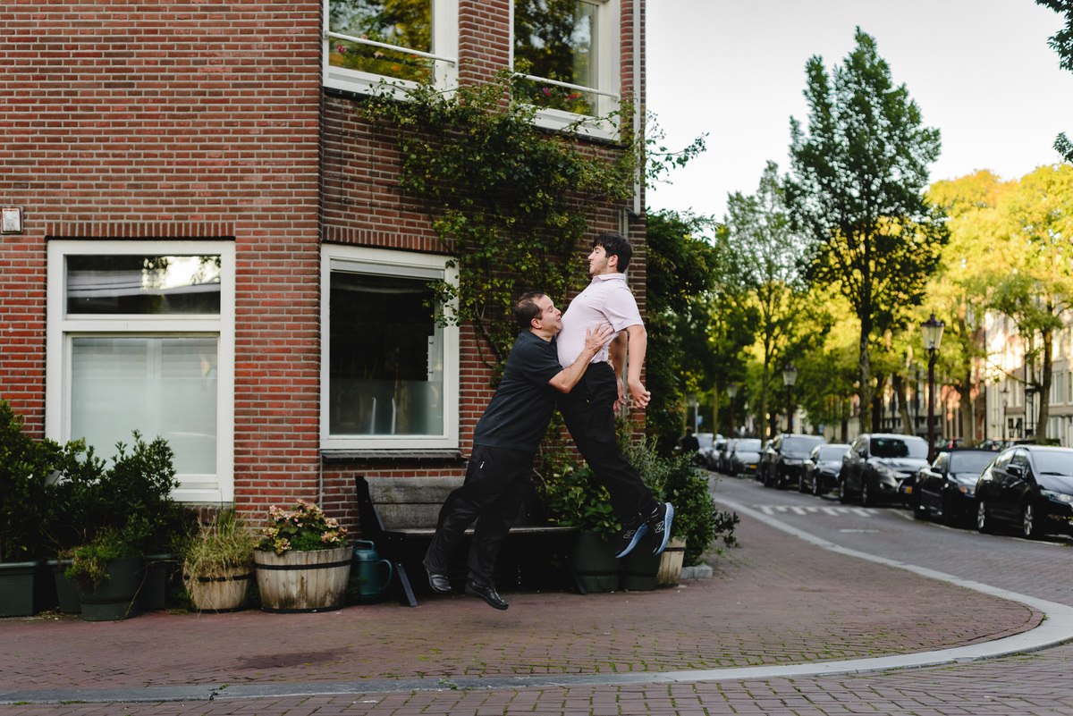 Parent and child moment captured naturally in Amsterdam streets