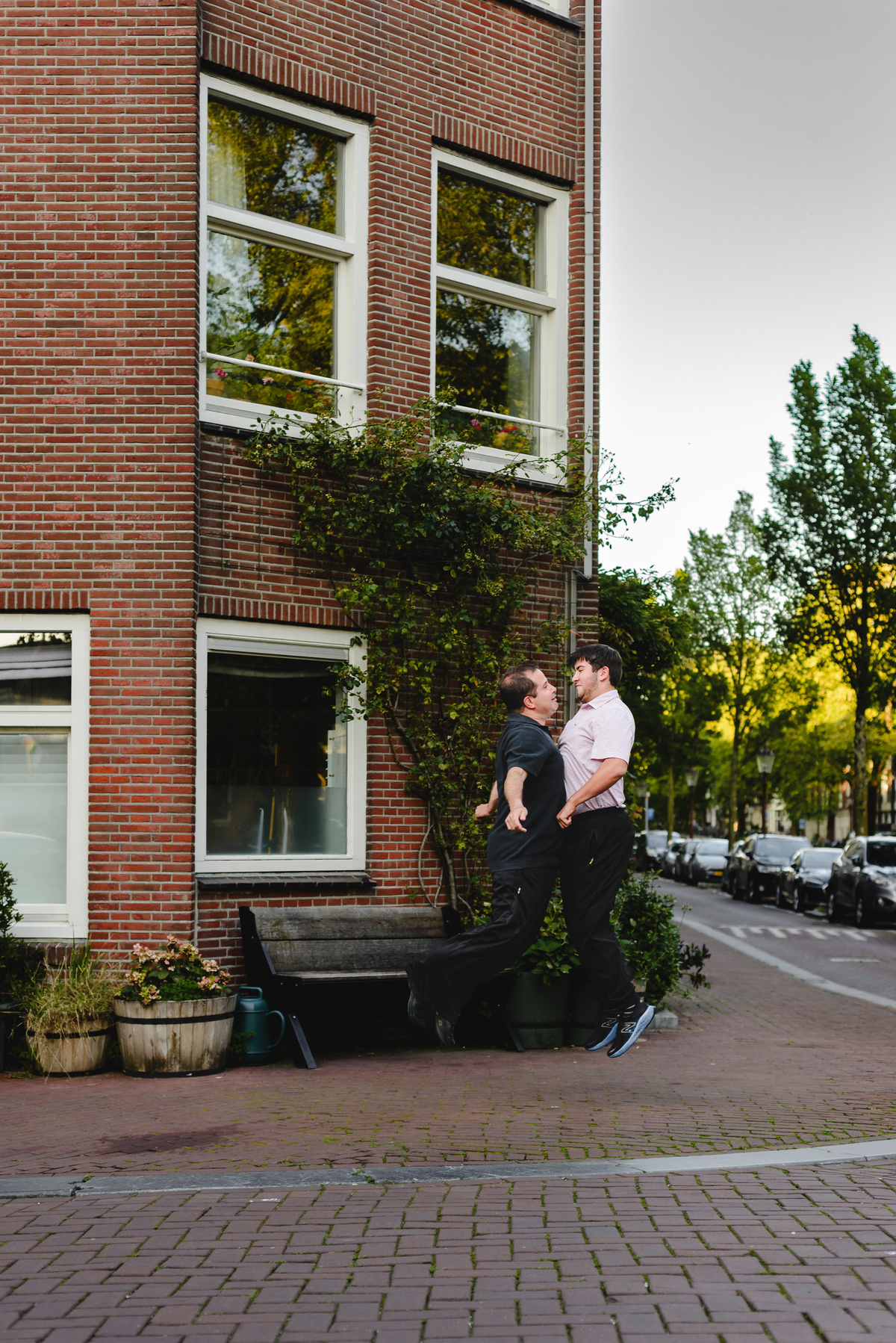 Parent and child moment captured naturally in Amsterdam streets