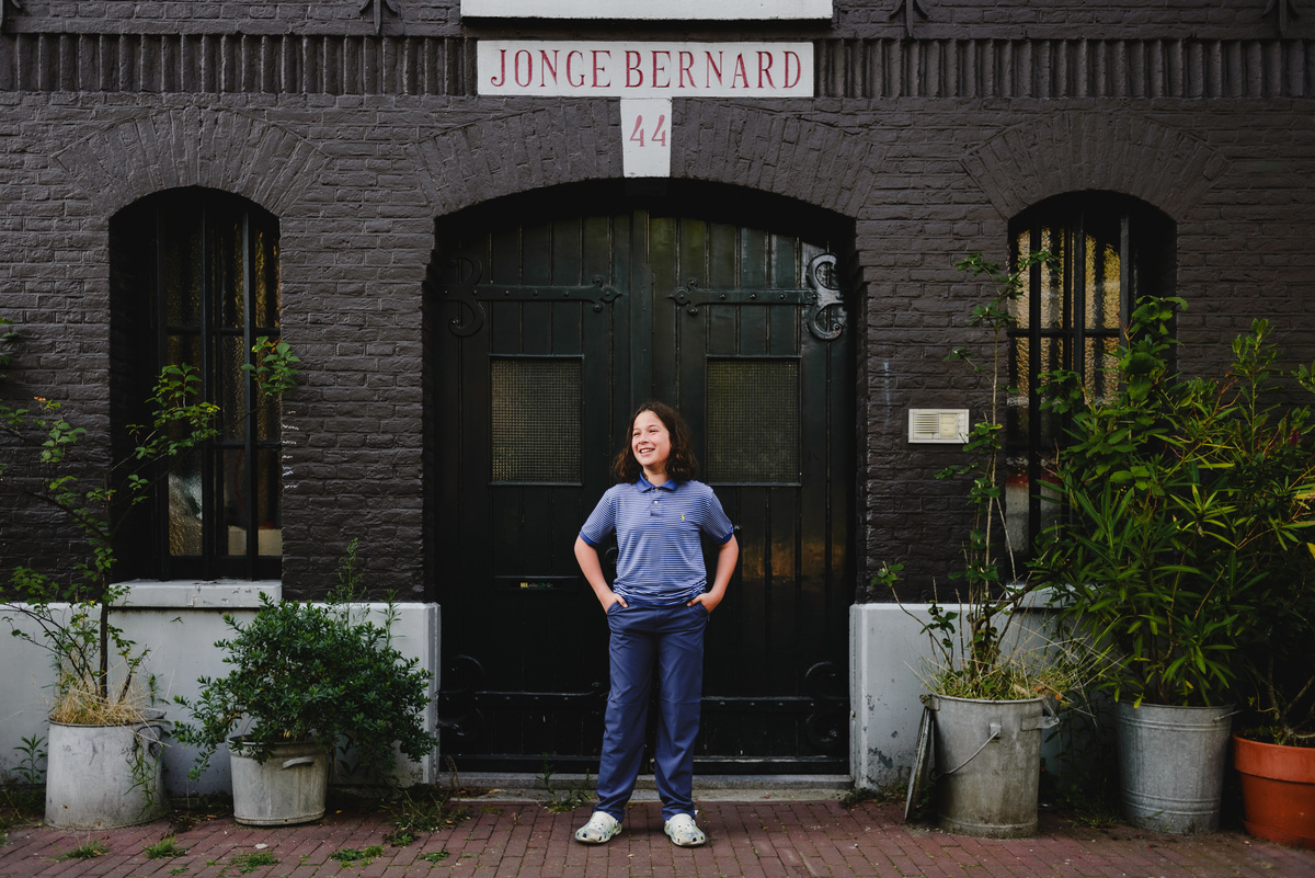 Child portrait during family photo session in Amsterdam with canal background
