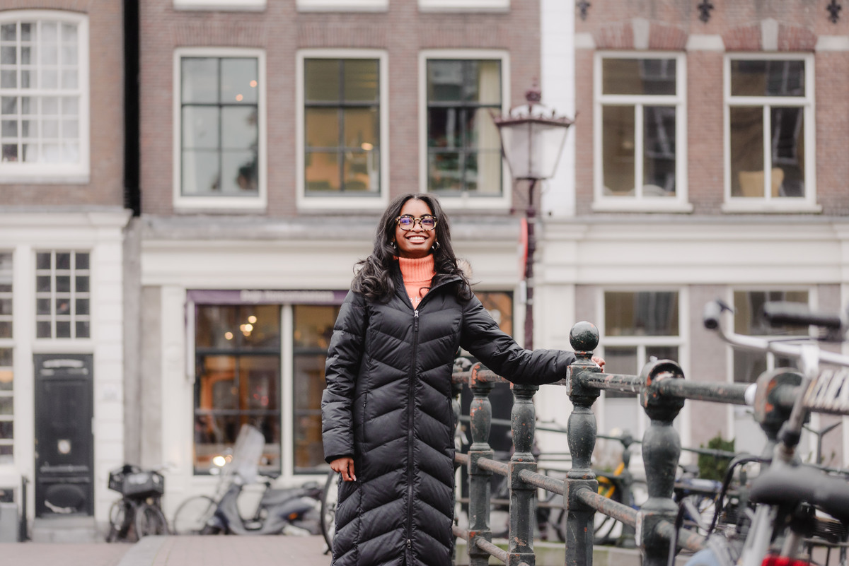 Solo portrait of a teenage girl walking along an Amsterdam canal