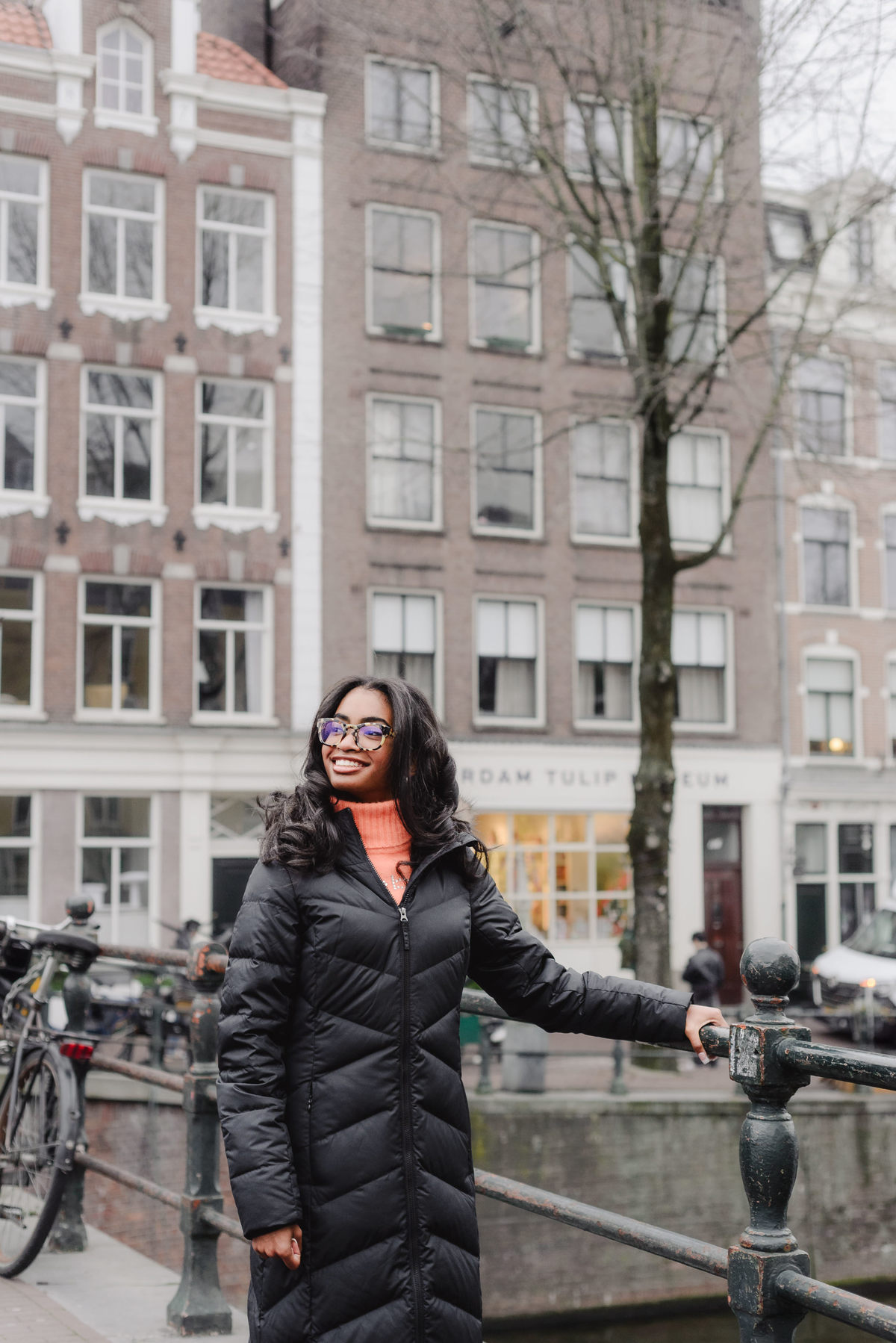 Solo portrait of a teenage girl walking along an Amsterdam canal