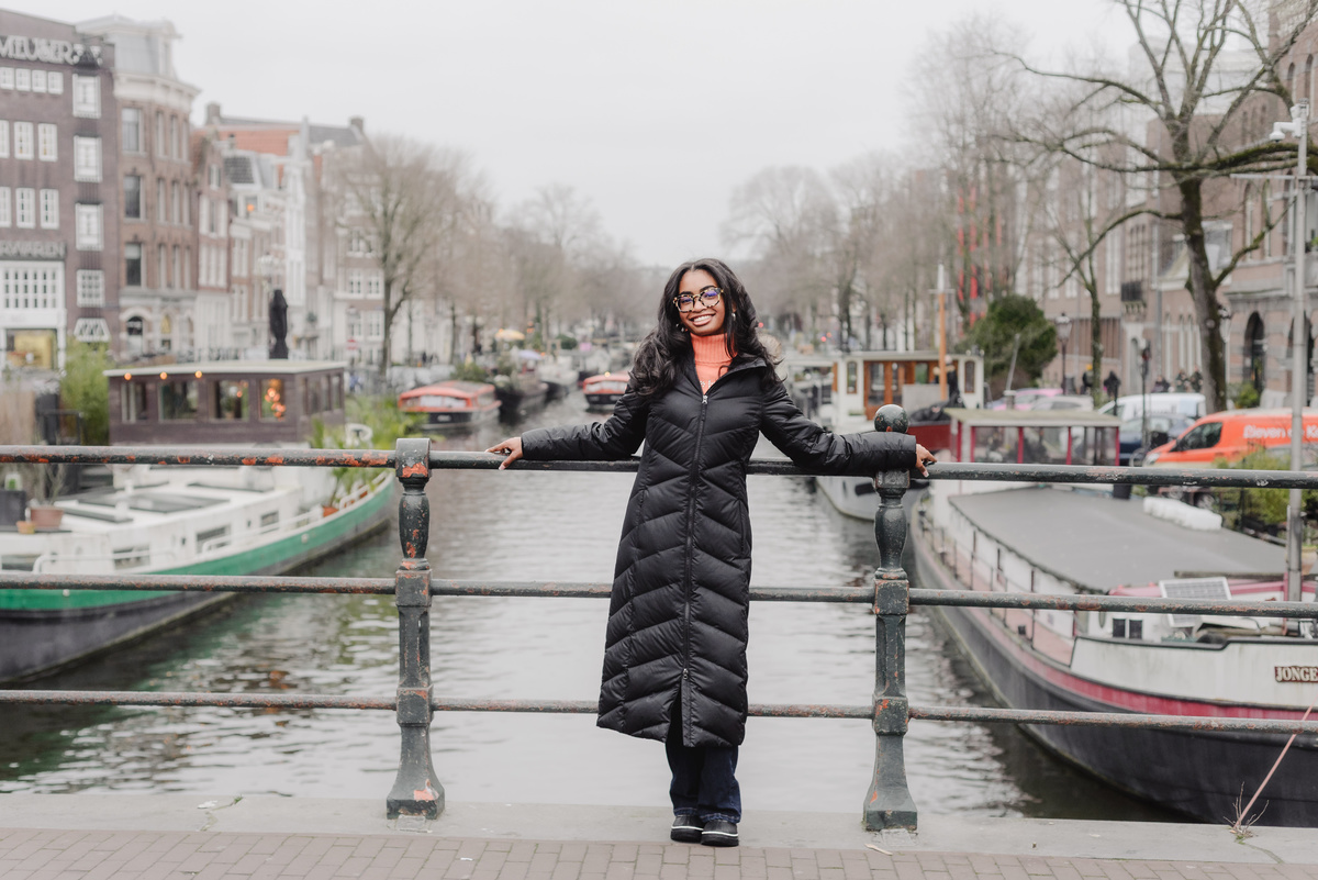 Solo portrait of a teenage girl walking along an Amsterdam canal