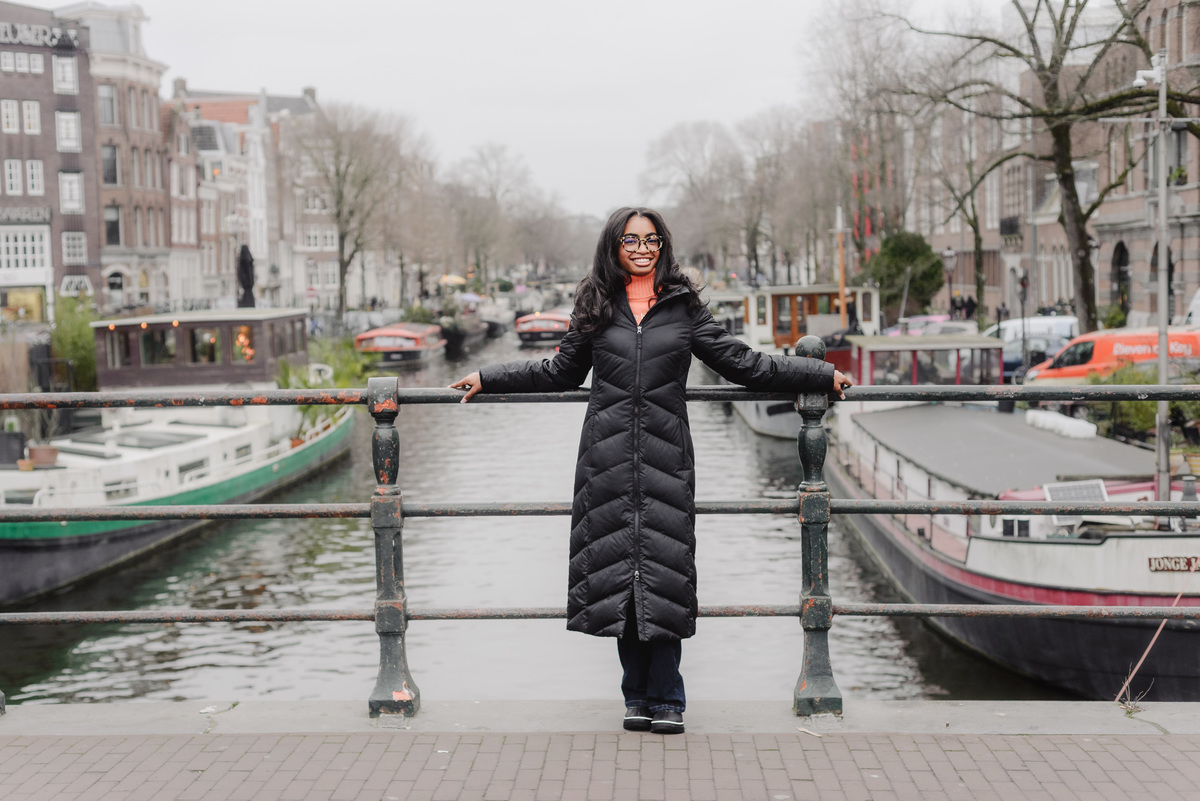 Solo portrait of a teenage girl walking along an Amsterdam canal