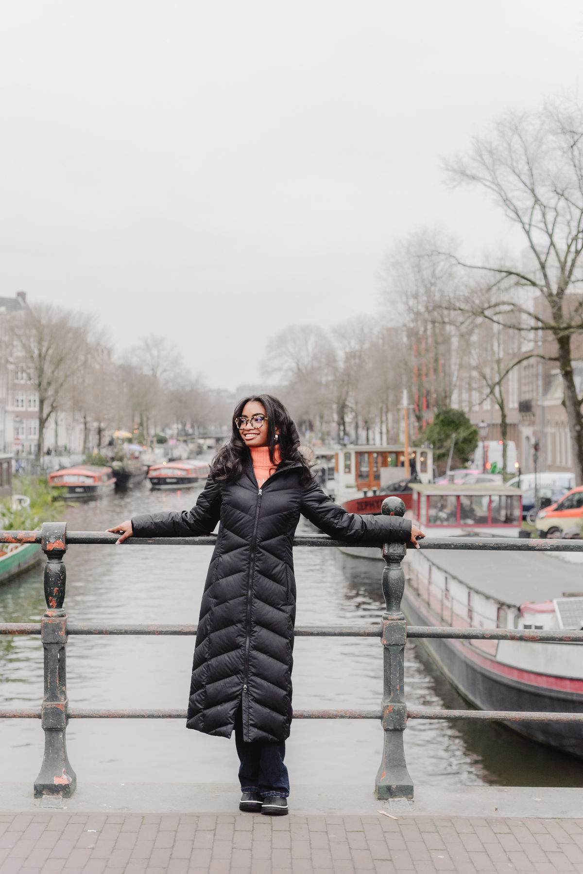 Solo portrait of a teenage girl walking along an Amsterdam canal