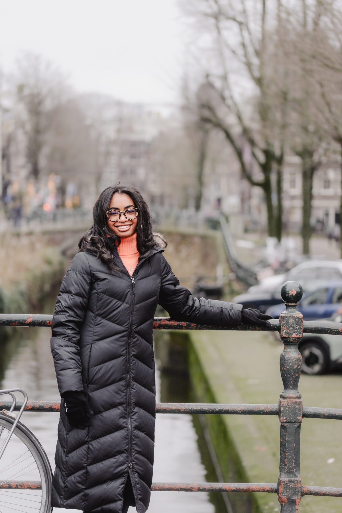 Teenage girl walking along canals in Amsterdam during a vacation photo shoot