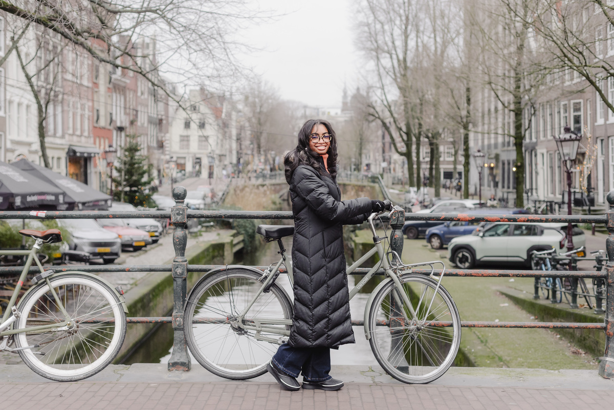 Teenage girl walking along canals in Amsterdam during a vacation photo shoot