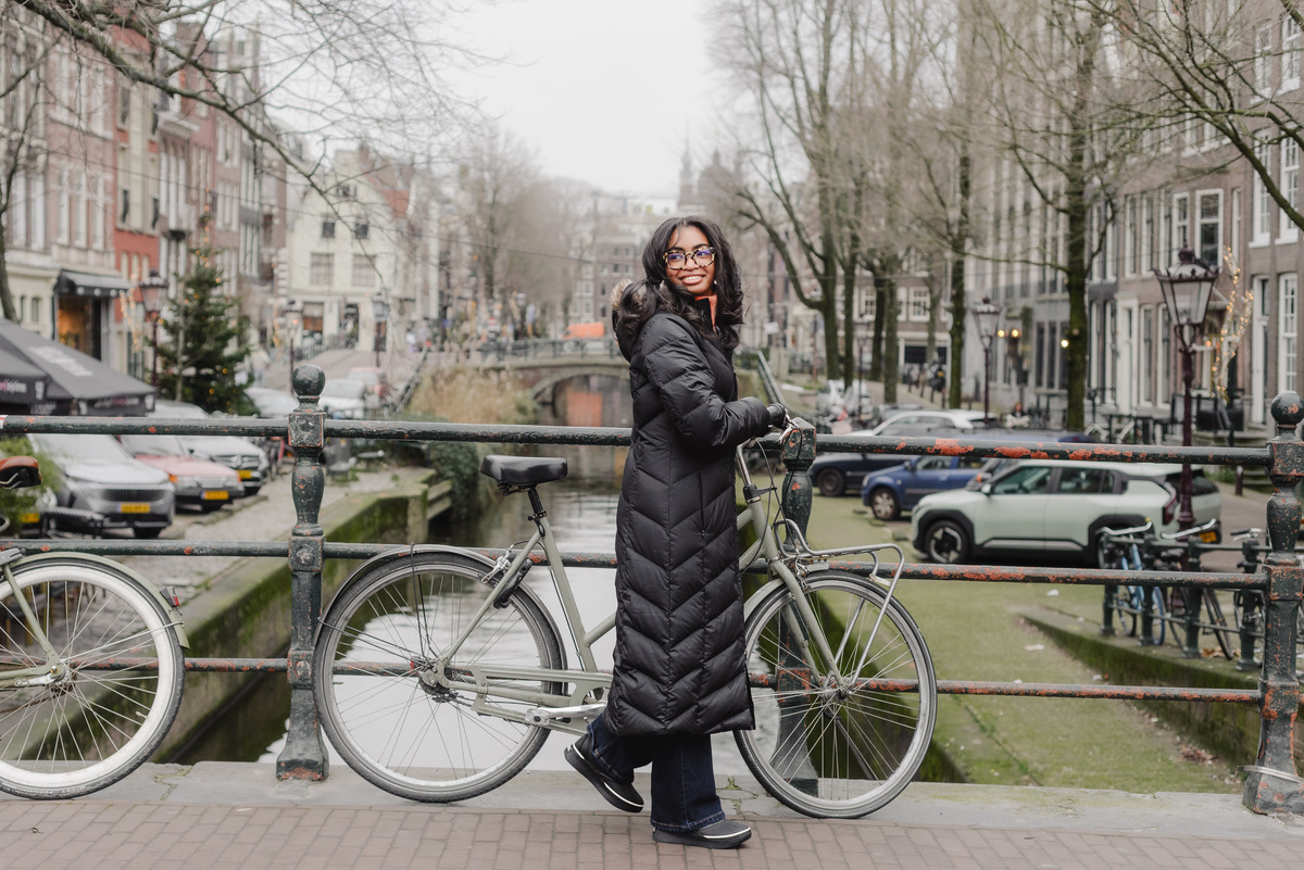 Teenage girl walking along canals in Amsterdam during a vacation photo shoot