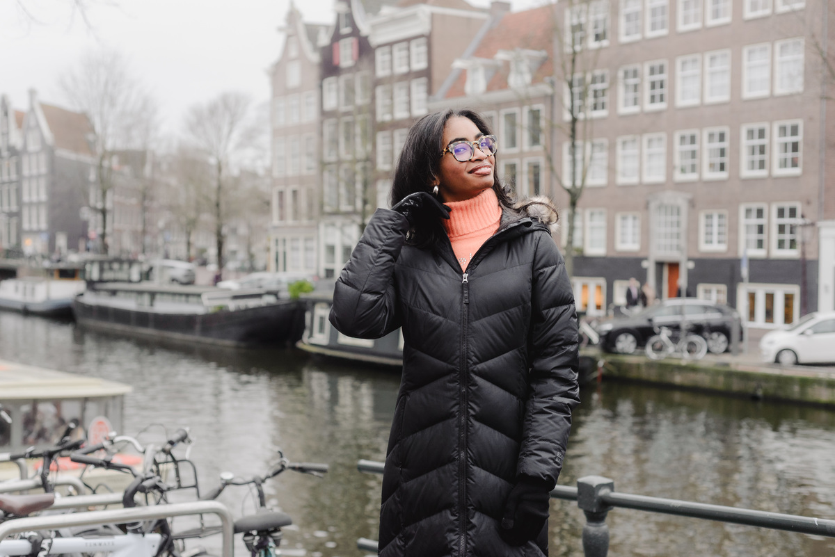 Teenage girl walking along canals in Amsterdam during a vacation photo shoot