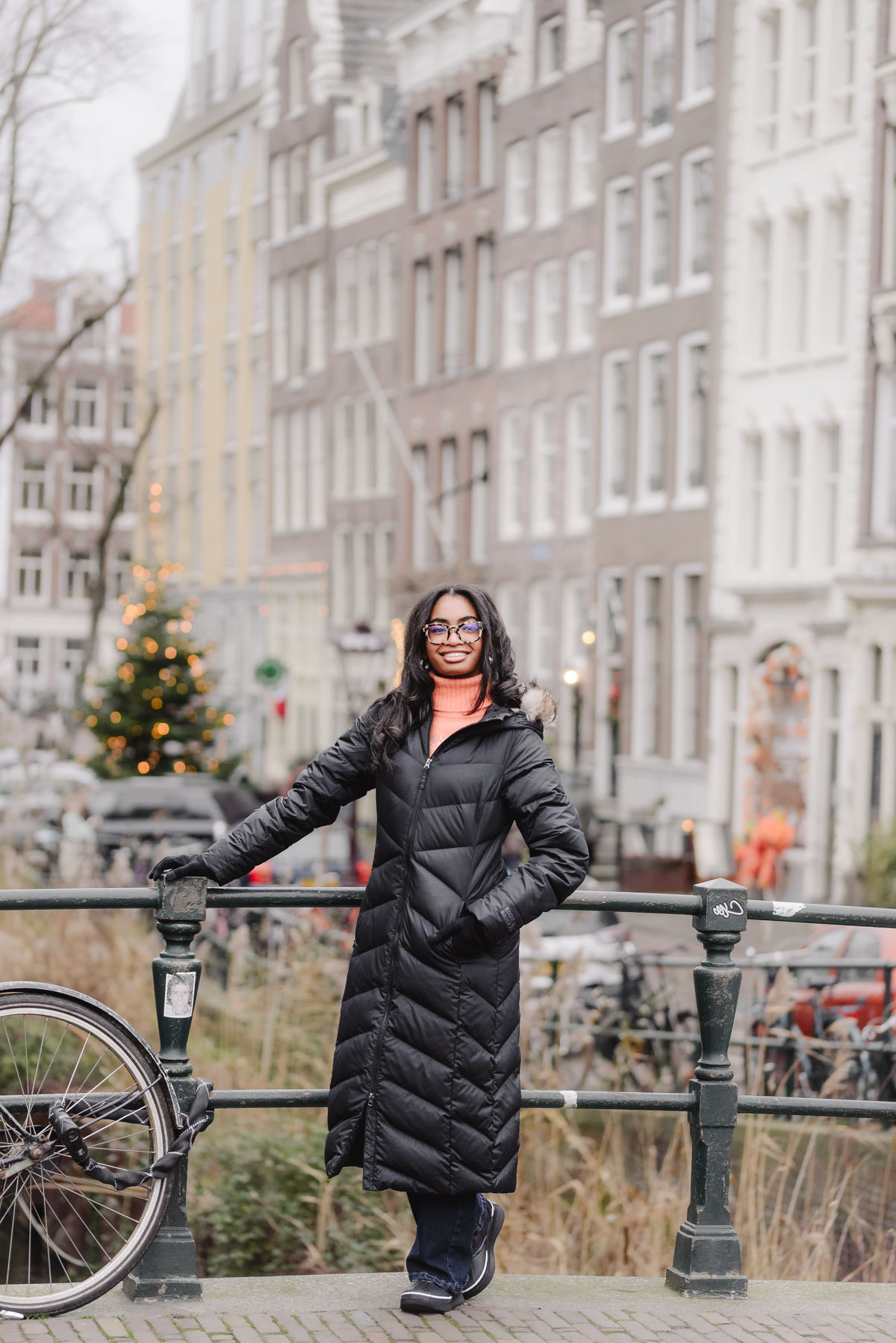 Teenage girl walking along canals in Amsterdam during a vacation photo shoot