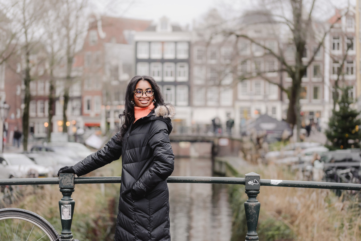 Teenage girl walking along canals in Amsterdam during a vacation photo shoot