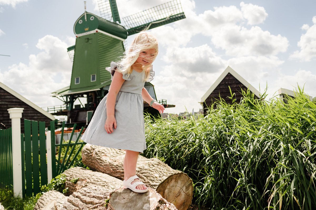 Kid portrait with traditional Dutch windmills in background