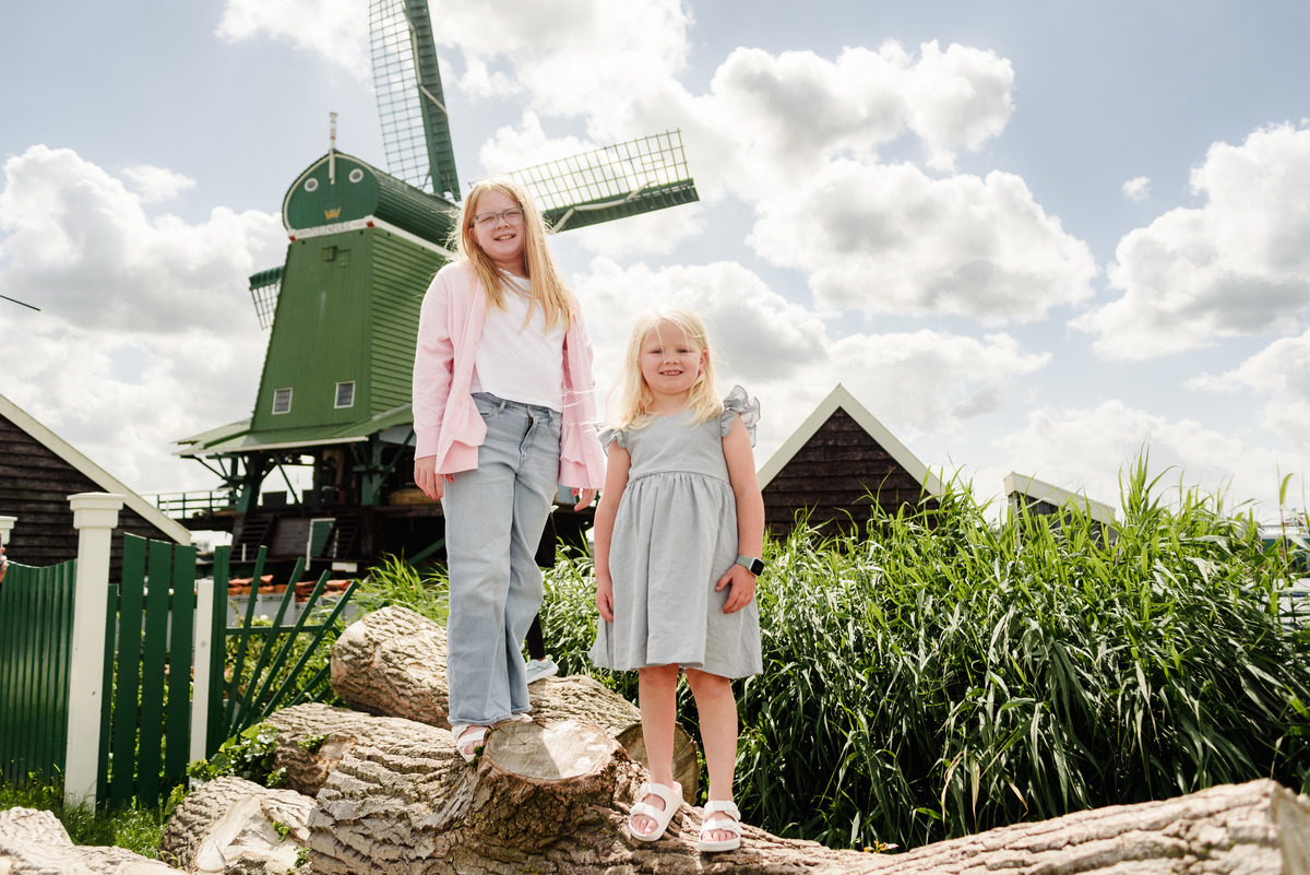 Kids portrait with traditional Dutch windmills in background