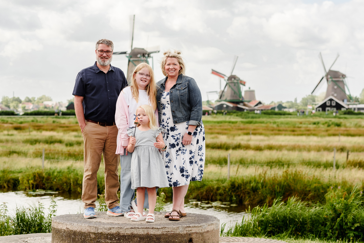 Family portrait with famous windmills in the background at Zaanse Schans village 