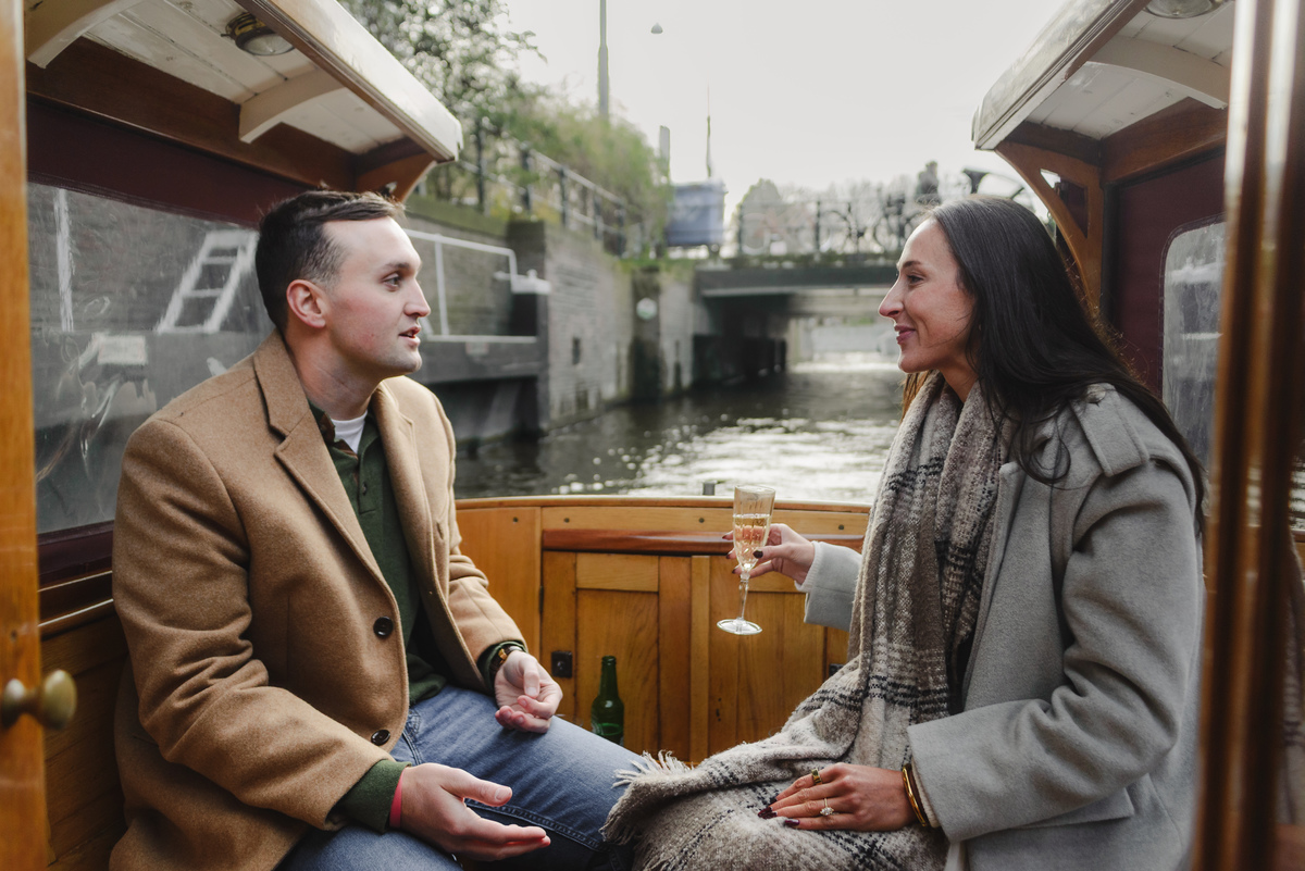 couple celebrating proposal on canal boat