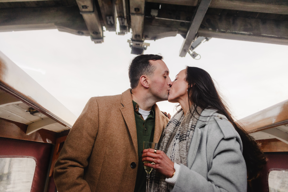couple celebrating proposal on canal boat