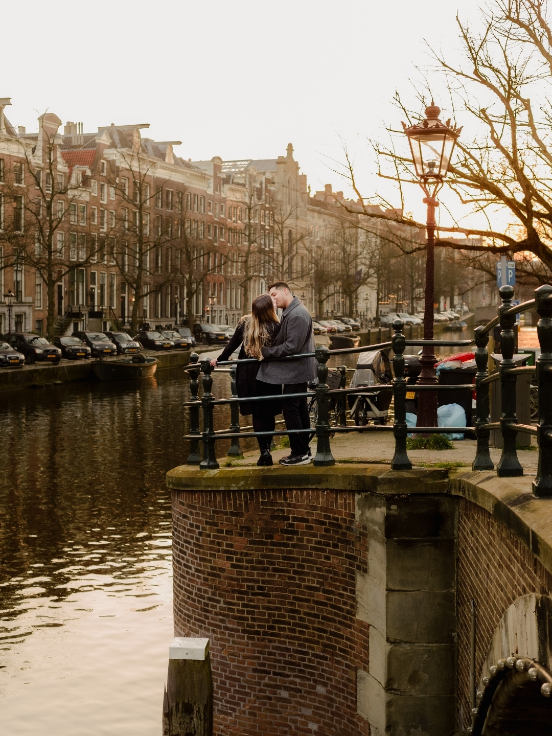 Newly engaged couple walking along Amsterdam canals after proposal