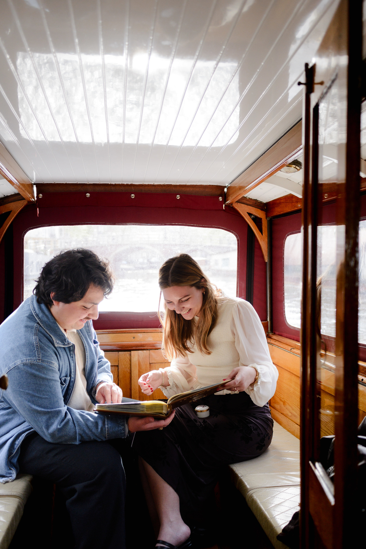 A couple is looking at the pages of the new album, our adventures book, on the style of the Up movie.