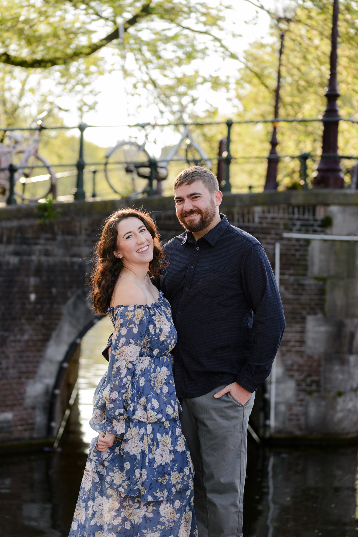 Couple is smiling to the camera with a beautiful background. This is in the canal bell, one of the best locations to photograph in the city. 