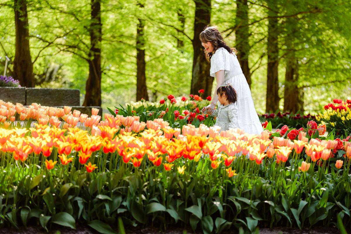 Mother and young daughter surrounded by colorful tulips at Keukenhof Gardens in the Netherlands