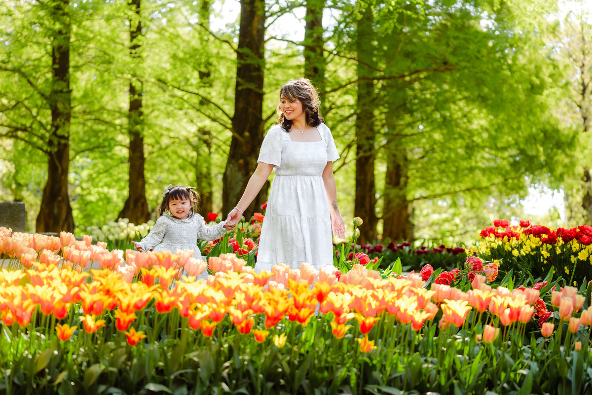 Mother and young daughter surrounded by colorful tulips at Keukenhof Gardens in the Netherlands
