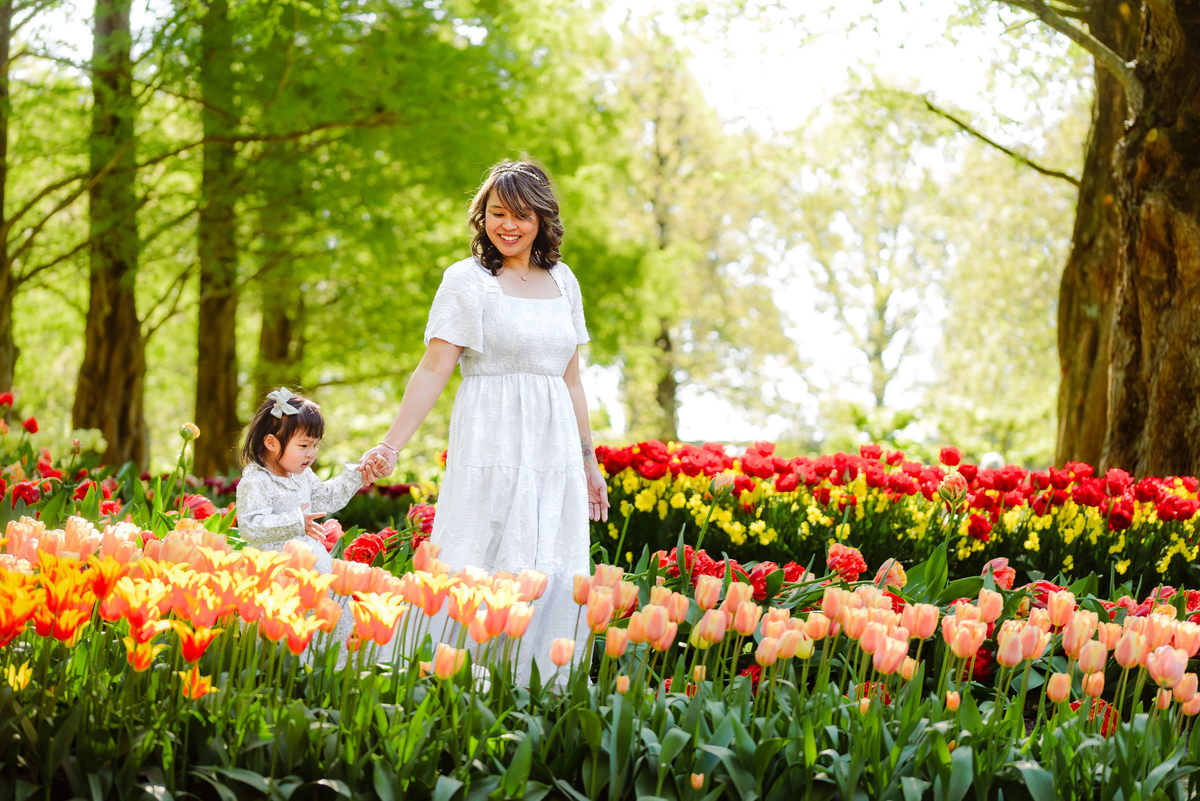 Mother and young daughter surrounded by colorful tulips at Keukenhof Gardens in the Netherlands